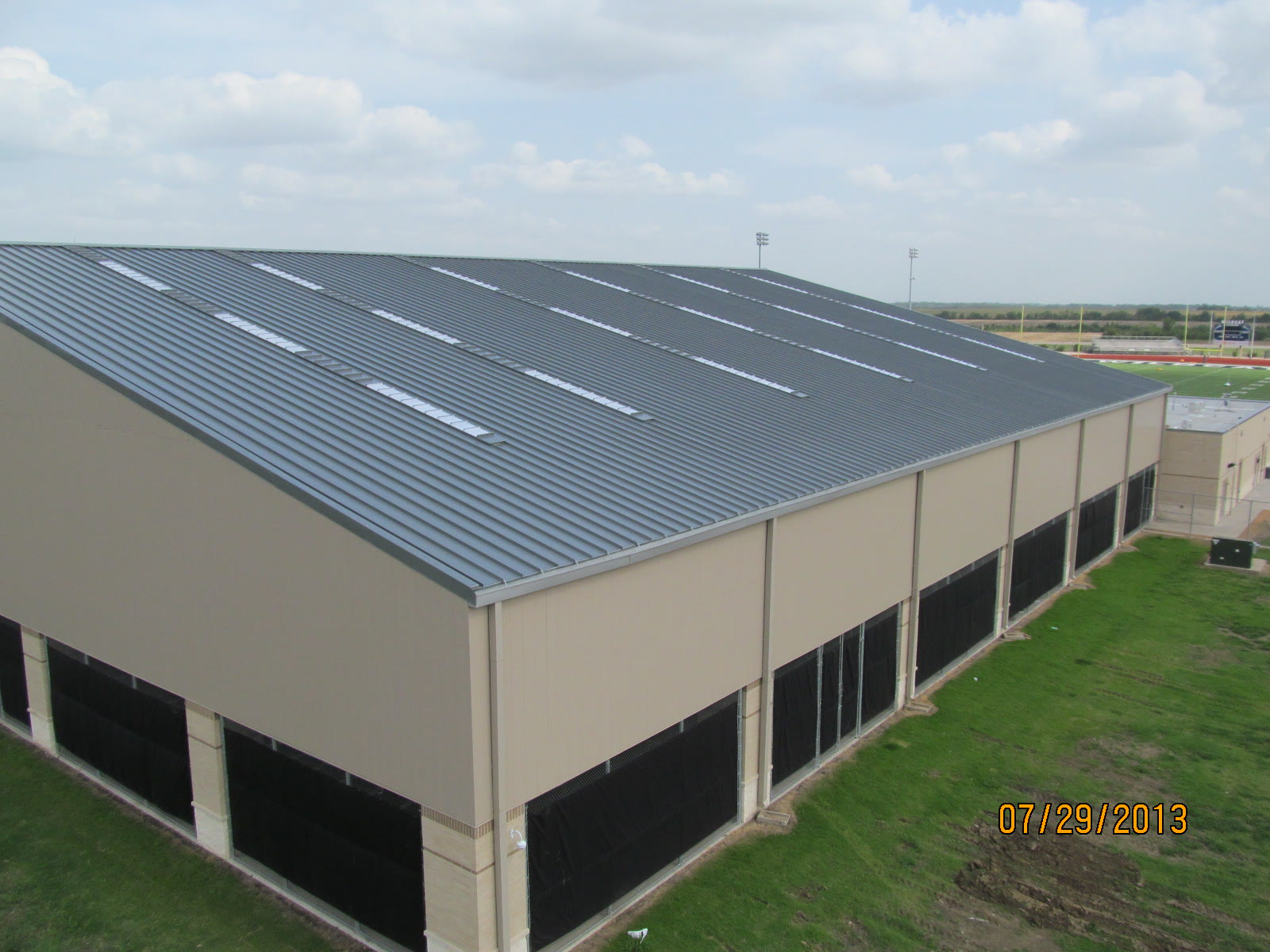 Standing-seam metal roof over a school athletic facility