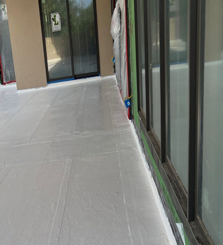 PMMA waterproofing membrane at a door threshold and window wall on a terrace