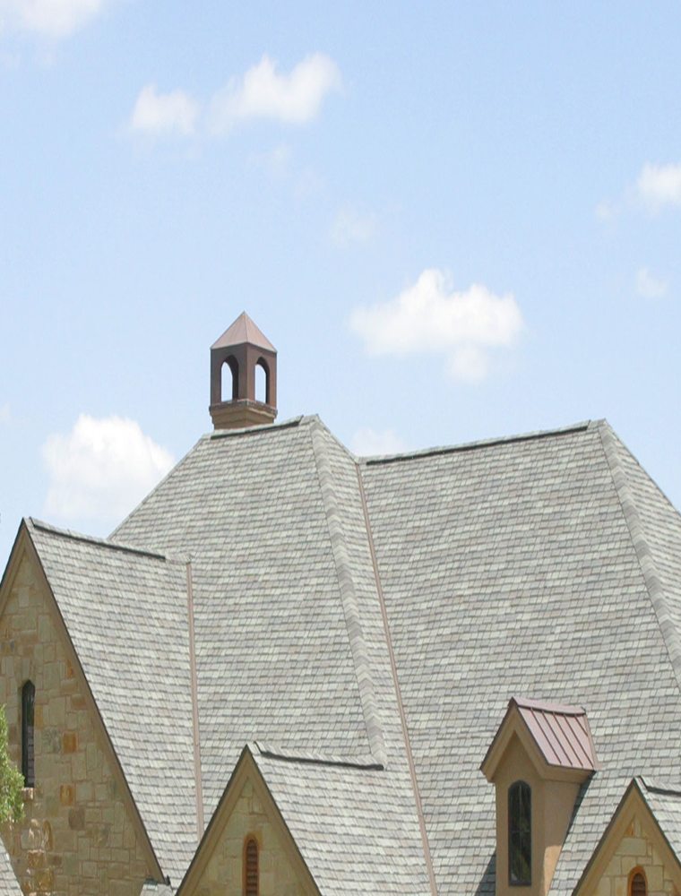 Grey natural-slate roof with a copper-capped cupola