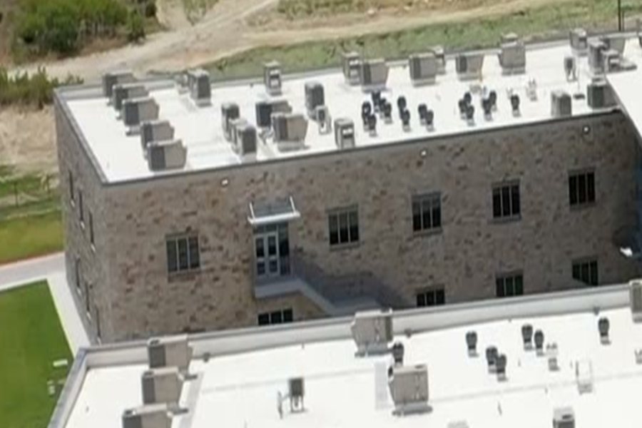 Low-slope membrane roof field with rooftop equipment